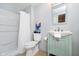 Clean bathroom featuring a green vanity, toilet, and shower with a white curtain at 534 1/2 Amos Dr, Zionsville, IN 46077