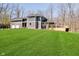 Beautifully landscaped, gray two-story home with a large, lush green lawn and a three car garage at 534 1/2 Amos Dr, Zionsville, IN 46077