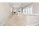 Upstairs hallway with plush carpet, large window and view to an office area at 534 1/2 Amos Dr, Zionsville, IN 46077