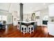 Modern kitchen featuring a large island with seating, stainless steel appliances, and hardwood floors at 534 1/2 Amos Dr, Zionsville, IN 46077