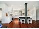 Open kitchen with white cabinetry, quartz countertops, hardwood floors and stainless steel appliances at 534 1/2 Amos Dr, Zionsville, IN 46077