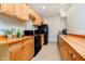 Functional kitchen featuring wood cabinets and black appliances at 534 1/2 Amos Dr, Zionsville, IN 46077