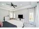 Bright main bedroom features large windows, tray ceiling, and ceiling fan at 534 1/2 Amos Dr, Zionsville, IN 46077