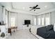 Spacious main bedroom featuring tray ceilings, ceiling fan, and bright windows at 534 1/2 Amos Dr, Zionsville, IN 46077