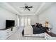 Spacious main bedroom featuring tray ceilings, ceiling fan, and bright windows at 534 1/2 Amos Dr, Zionsville, IN 46077