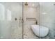 Modern bathroom featuring a glass enclosed shower and a soaking tub at 534 1/2 Amos Dr, Zionsville, IN 46077