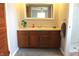 Bathroom vanity featuring a wooden cabinet, mirror, decor and a sink with fixtures at 5582 E State Road 144, Mooresville, IN 46158