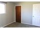 This bedroom has modern gray walls and carpet, two entry doors, and a window at 5582 E State Road 144, Mooresville, IN 46158
