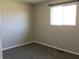 Cozy bedroom with neutral gray walls and carpet, with a window allowing natural light at 5582 E State Road 144, Mooresville, IN 46158