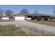 Lovely brick ranch with an attached garage and a spacious gravel driveway at 5582 E State Road 144, Mooresville, IN 46158