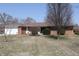 Quaint brick ranch with mature landscaping and a charming front yard at 5582 E State Road 144, Mooresville, IN 46158