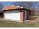 Exterior view of the detached one car garage with white door at 5582 E State Road 144, Mooresville, IN 46158