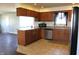 Bright kitchen features tile floors, wooden cabinets, stainless steel appliances and a corner sink at 5582 E State Road 144, Mooresville, IN 46158