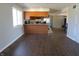 Open concept kitchen with wooden cabinets and a view into the living space offers natural light at 5582 E State Road 144, Mooresville, IN 46158