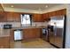 Bright kitchen features tile floors, wooden cabinets, stainless steel appliances, and plenty of counter space at 5582 E State Road 144, Mooresville, IN 46158