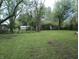 Expansive backyard with mature trees and lush green lawn, ideal for outdoor activities and enjoyment at 5603 S Randolph St, Indianapolis, IN 46227