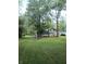 Picturesque backyard with a firepit and mature trees, perfect for outdoor gatherings and relaxation at 5603 S Randolph St, Indianapolis, IN 46227
