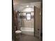 Bathroom with tub, tiled wall, mosaic detail, and tiled floor at 5603 S Randolph St, Indianapolis, IN 46227
