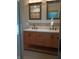 Bathroom with double sinks, shaker cabinets, tile backsplash, and decorative mirrors at 5603 S Randolph St, Indianapolis, IN 46227