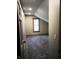 Well-lit bedroom with plush carpeting and a window with wood trim, ensuring a restful ambiance at 5603 S Randolph St, Indianapolis, IN 46227