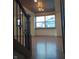 Bright entryway with hardwood floors, wood-paneled ceiling and stairs with metal railings at 5603 S Randolph St, Indianapolis, IN 46227