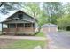 Beautiful home with blue siding, front porch, a detached garage, and lush greenery at 5603 S Randolph St, Indianapolis, IN 46227