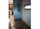 Hallway showing hardwood floors and a window with bright, natural light at 5603 S Randolph St, Indianapolis, IN 46227