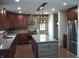 Kitchen featuring stainless steel appliances, island, and stone backsplash at 5603 S Randolph St, Indianapolis, IN 46227