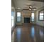 Spacious living room featuring hardwood floors and a stone fireplace at 5603 S Randolph St, Indianapolis, IN 46227