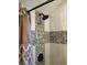 Close up of shower with mosaic tiled wall detail and shower head at 5603 S Randolph St, Indianapolis, IN 46227