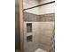 Shower with modern tile design, built in niches, and a shower curtain at 5603 S Randolph St, Indianapolis, IN 46227