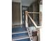 Staircase with dark steps, hardwood rails and wrought iron balusters at 5603 S Randolph St, Indianapolis, IN 46227