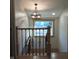 Staircase with oak rail, wrought iron balusters, and chandelier at 5603 S Randolph St, Indianapolis, IN 46227
