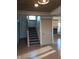 Staircase leading to the upper level with hardwood floors and a wooden railing at 5603 S Randolph St, Indianapolis, IN 46227