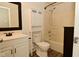 Well-lit bathroom featuring a sink and vanity combo, toilet, and shower-tub with tile and neutral color palette at 5909 Furnas Rd, Indianapolis, IN 46221