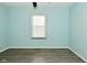 A simple bedroom with hard surface floors and a window at 5909 Furnas Rd, Indianapolis, IN 46221