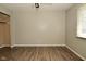A simple bedroom with hard surface floors and a window at 5909 Furnas Rd, Indianapolis, IN 46221