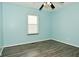 A simple bedroom with hard surface floors and a window at 5909 Furnas Rd, Indianapolis, IN 46221