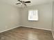 A simple bedroom with hard surface floors and a window at 5909 Furnas Rd, Indianapolis, IN 46221