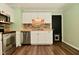 Bright kitchen features stainless steel appliances, white cabinetry and attractive backsplash at 5909 Furnas Rd, Indianapolis, IN 46221