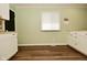 Bright kitchen features white cabinetry, butcher block counters and light green walls at 5909 Furnas Rd, Indianapolis, IN 46221