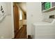 Washer, dryer, cabinets and shelves are seen from a hallway perspective at 5909 Furnas Rd, Indianapolis, IN 46221
