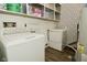 Convenient laundry room with modern washer and dryer units and built in storage shelves at 5909 Furnas Rd, Indianapolis, IN 46221