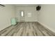 Inviting living room featuring durable wood-look vinyl flooring and modern wall-mounted television at 5909 Furnas Rd, Indianapolis, IN 46221