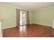 Bright living room with wood-look flooring and a sliding glass door to the outside at 5909 Furnas Rd, Indianapolis, IN 46221