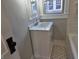 Updated bathroom with a stylish vanity, modern fixtures, and classic tiled floors at 5915 Winthrop Ave, Indianapolis, IN 46220