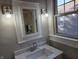 Bathroom featuring a new vanity with a marble countertop and modern lighting at 5915 Winthrop Ave, Indianapolis, IN 46220