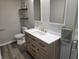 Updated bathroom vanity features a white quartz countertop and wood drawers at 5915 Winthrop Ave, Indianapolis, IN 46220