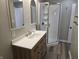Beautiful bathroom with updated vanity, mirror, and new tile floors at 5915 Winthrop Ave, Indianapolis, IN 46220