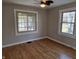 Charming bedroom with hardwood floors, ample natural light, and ceiling fan at 5915 Winthrop Ave, Indianapolis, IN 46220